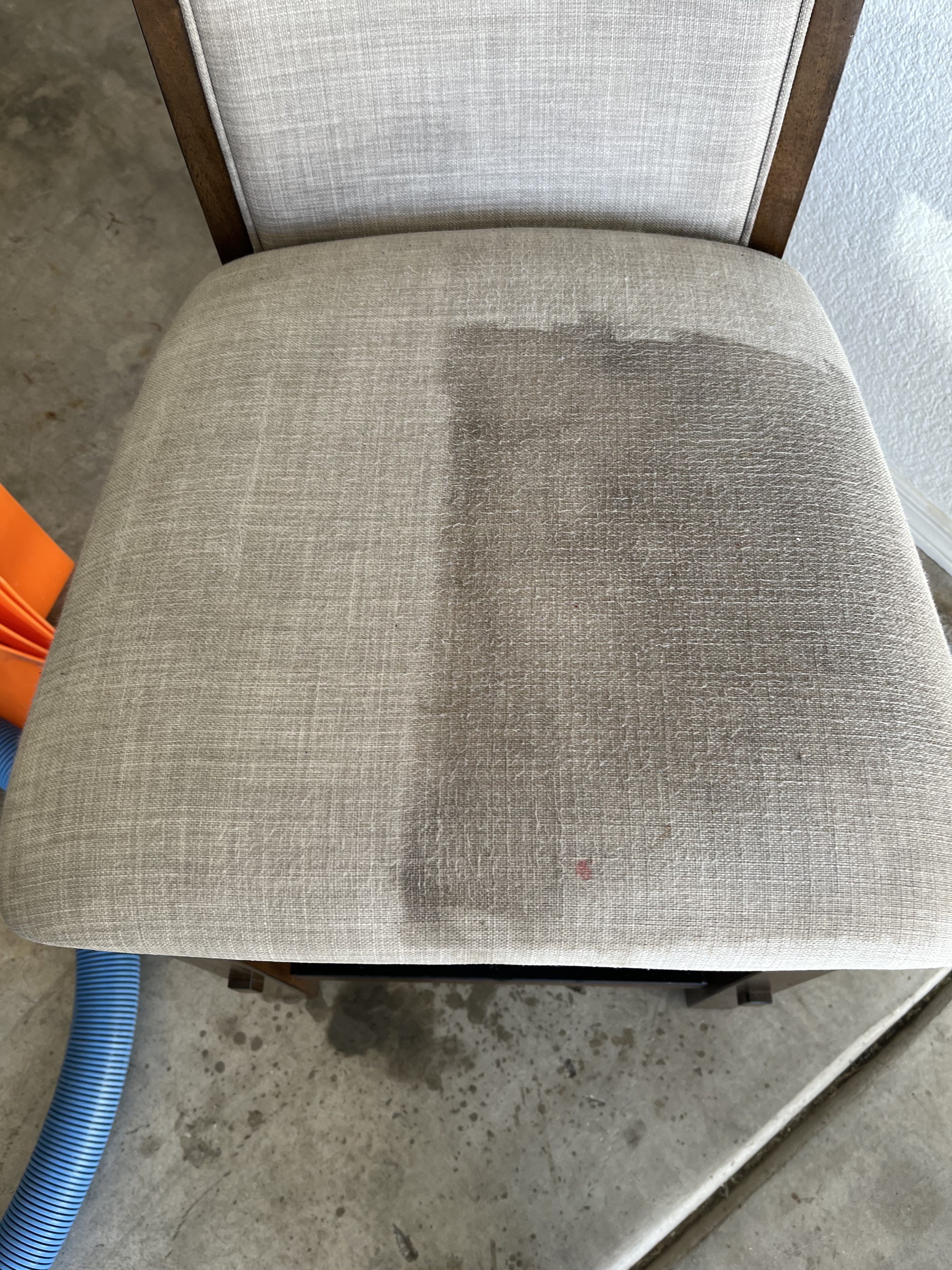 a chair halfway cleaned with professional upholstery cleaning